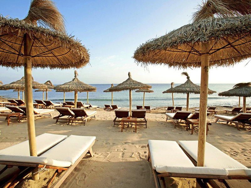 Front of zip tote bag with white canvas, black canvas straps and handle, and black zipper pulls.